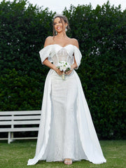 Elegant And Romantic Off-Shoulder Wedding Dress With Pleating Details And Embroidered Fabric.