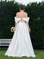 Elegant And Romantic Off-Shoulder Wedding Dress With Pleating Details And Embroidered Fabric.