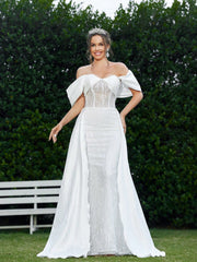 Elegant And Romantic Off-Shoulder Wedding Dress With Pleating Details And Embroidered Fabric.