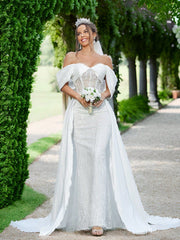 Elegant And Romantic Off-Shoulder Wedding Dress With Pleating Details And Embroidered Fabric.