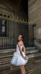 Romantic ivory corset dress with flowing tulle skirt and delicate bows accents - timeless beauty. Perfect for weddings or special occasions.