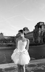 Romantic ivory corset dress with flowing tulle skirt and delicate bows accents - timeless beauty. Perfect for weddings or special occasions.