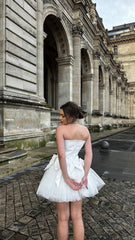 Romantic ivory corset dress with flowing tulle skirt and delicate bows accents - timeless beauty. Perfect for weddings or special occasions.